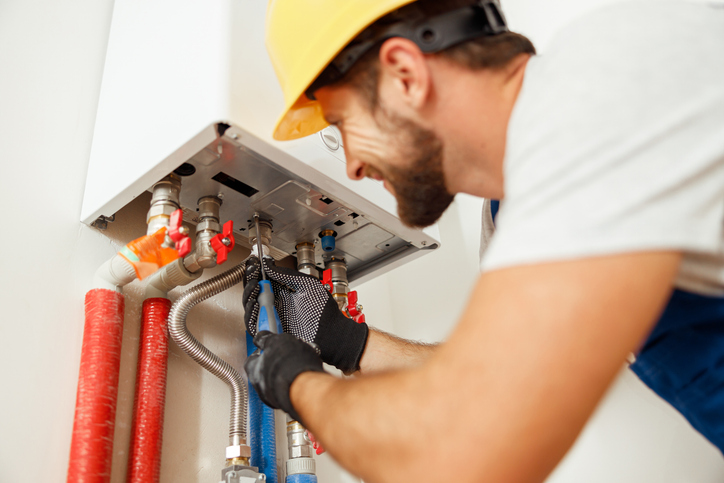 plumber fixing boiler