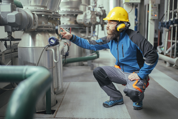Side view of a focused heating plant worker.